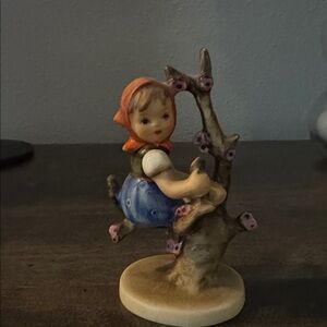 Apple Tree Girl Hummel Figurine with Blue Dress and Pink Headscarf.